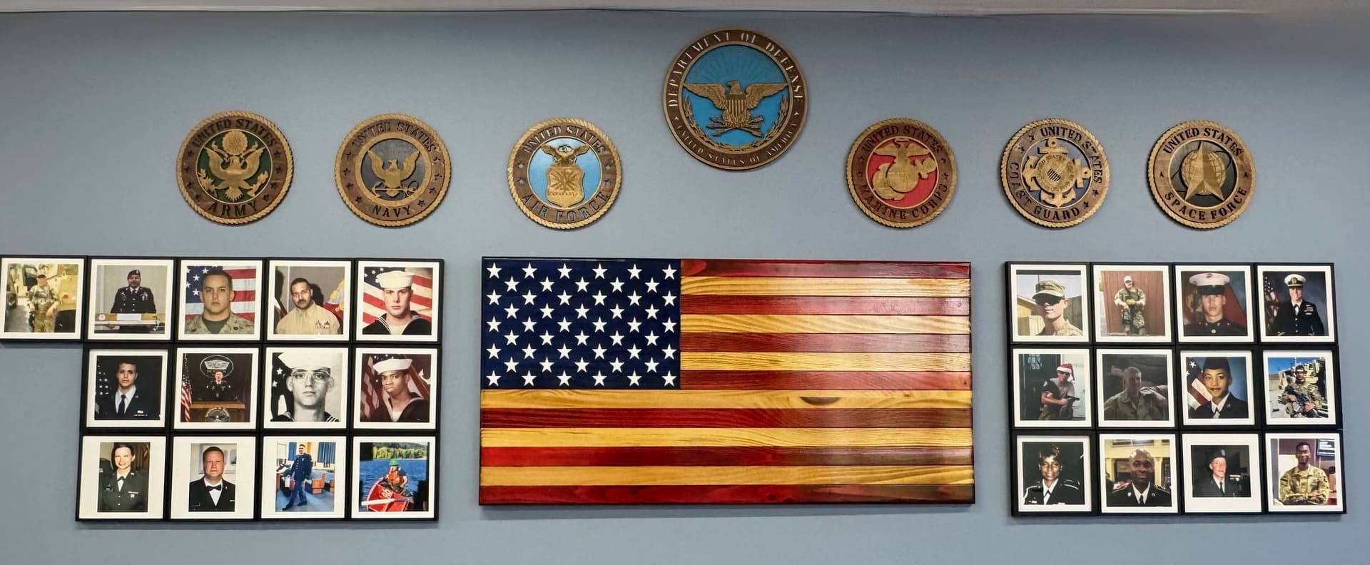 Honor wall with military service emblems