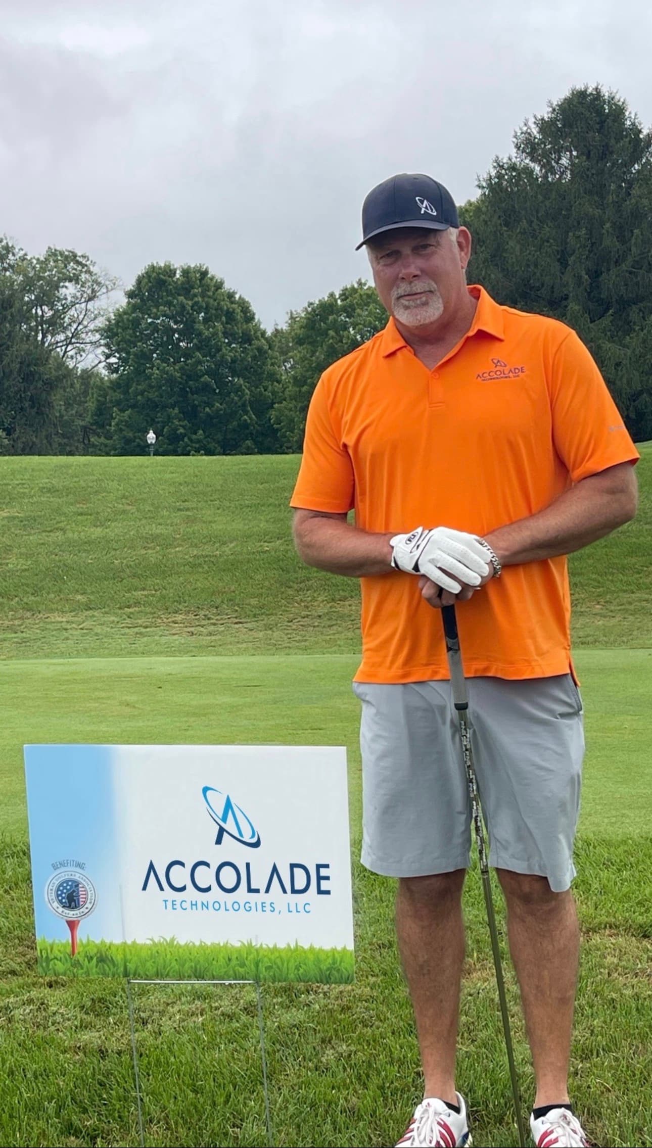 Scott at Hot August Cyber Cup golf tournament with Accolade Technologies sign